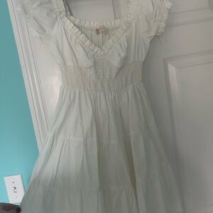 White sundress with smocked bodice sweetheart neckline and flutter sleeves
